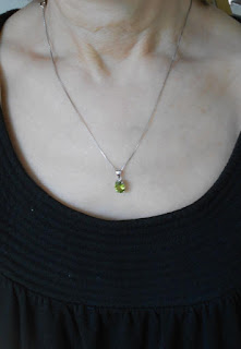 modeling peridot necklace with black top.jpeg