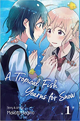 two teen girls hold hands, gaze into each others eyes, surrounded by a field of water and fish as though they were in or near an aquarium