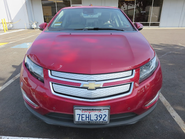 2014 Chevy Volt at body shop before repairs to hood, bumper and fender