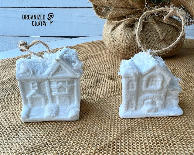 Photo of thrifted Christmas Snow Village ornaments painted white with faux snow.