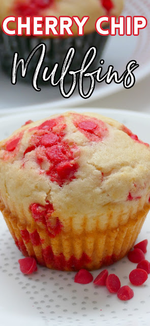 Muffin on a plate with cherry chips.