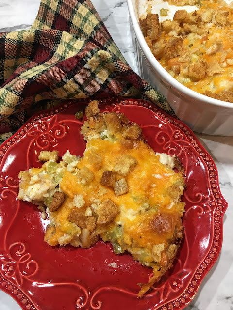 Hot Chicken Salad is a great way to feed a crowd, or serve as an appetizer! This dish is hot and cheesy chicken, and you get a crunch from the celery and croutons! Chasing Saturday's