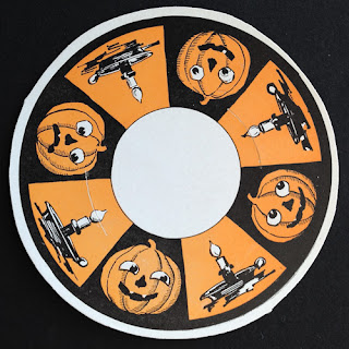 Example vintage Beistle diecut with candles and jack o'lanterns. Front.