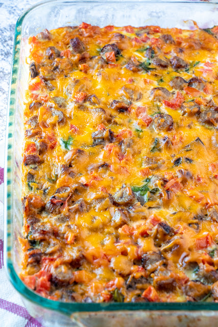 This breakfast casserole is great for Sunday morning breakfast, brunch or serve for the holidays! Tons of flavor from cheese, sausage, mushrooms, spinach, tomatoes, hash browns and onion. Simple to make and enough to feed the whole family!