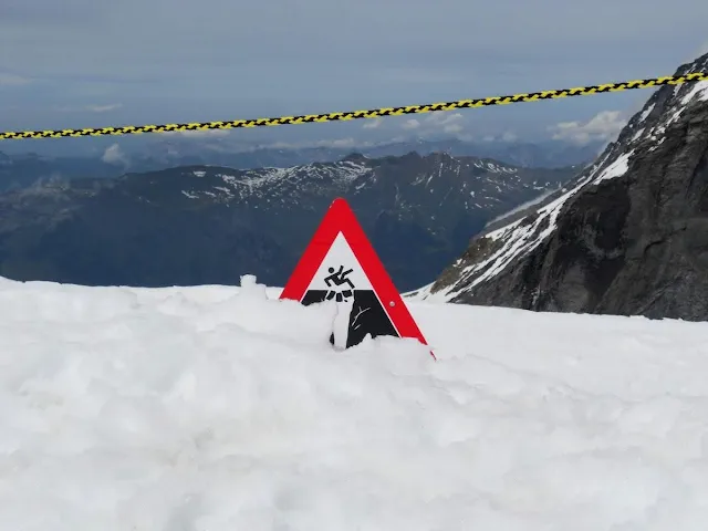 Warning sign buried in snow at Jungfraujoch