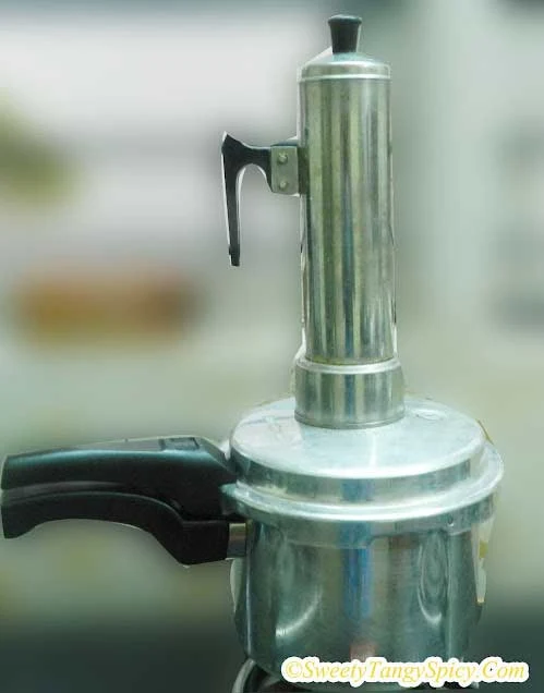 Steaming Kerala Puttu in a Puttu kutti on top of a boiling vessel.