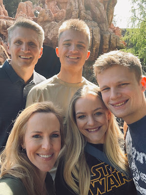 A family shot standing in front of Thunder Mountain