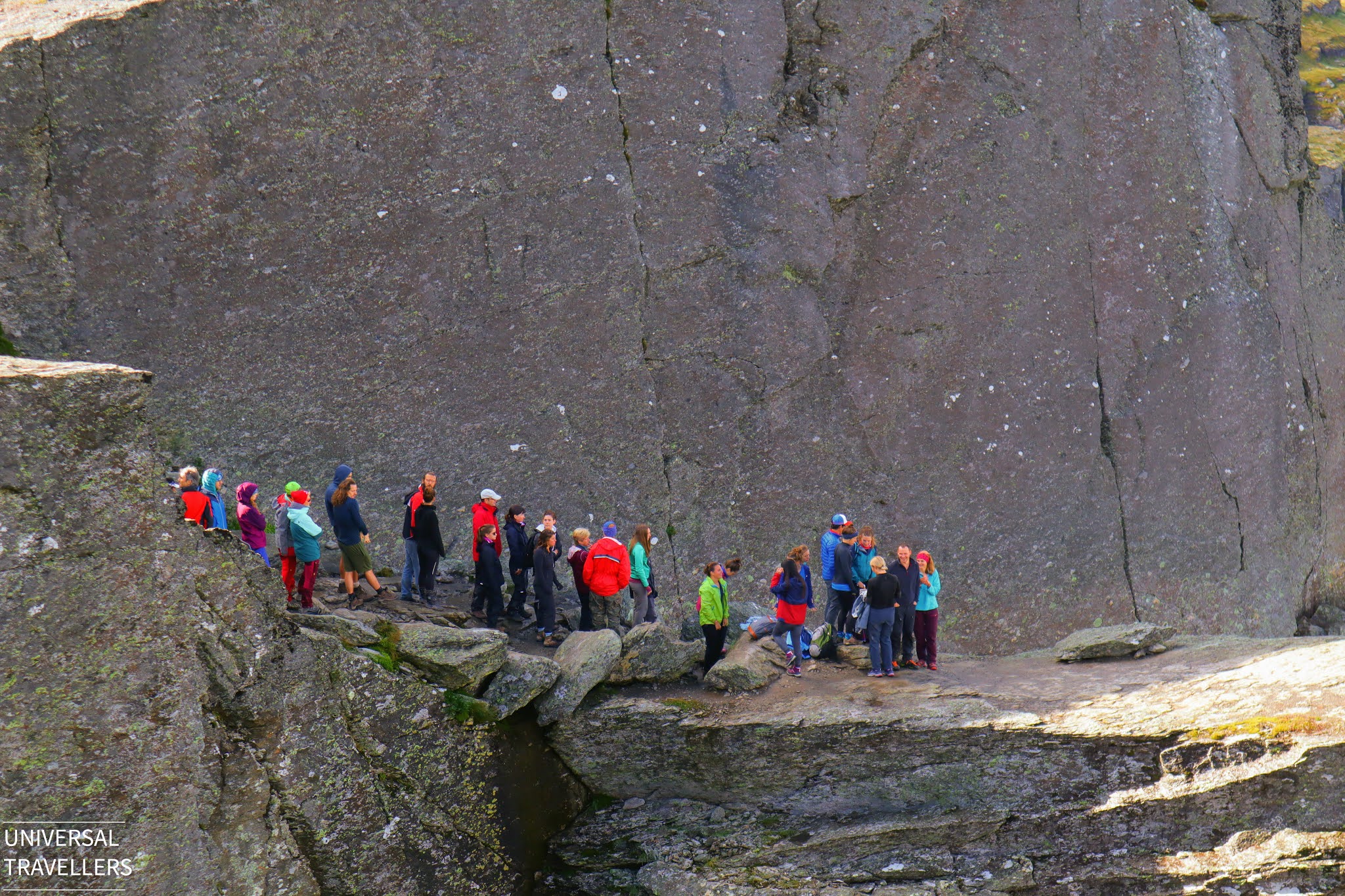 Hikers are waiting in the queue to reach the Trolltunga Cliff