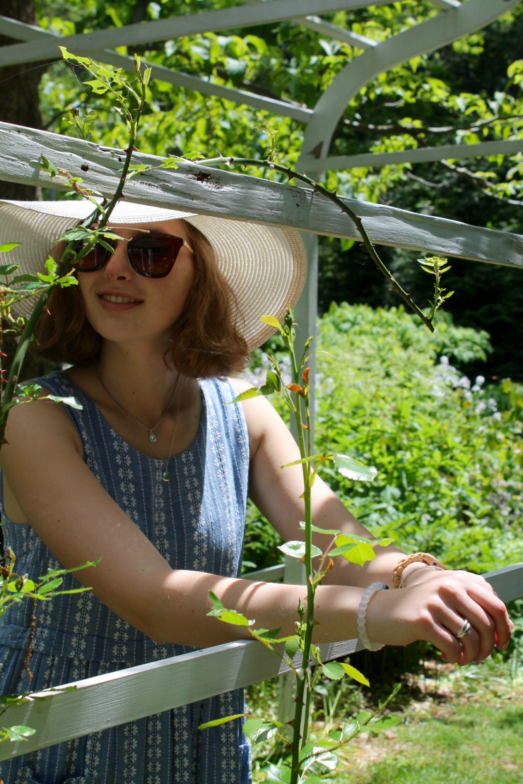 Short blue and white summer dress worn with a large wide rimmed white summer hat