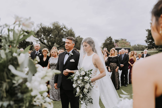 father of bride walking in his daughter