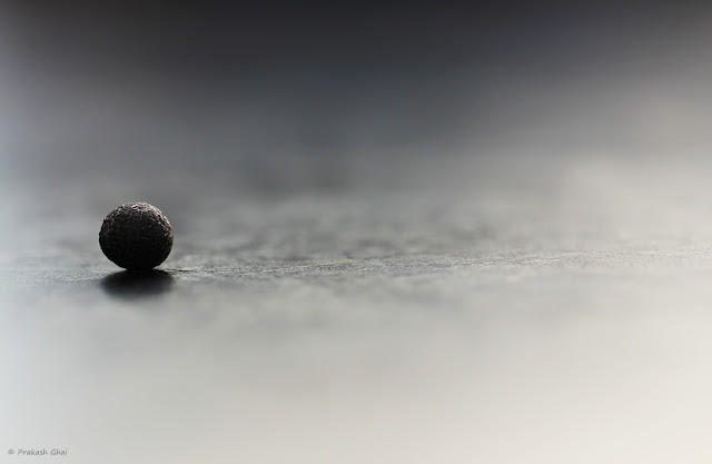  Photo of a Black Ball and its Reflection on a Table