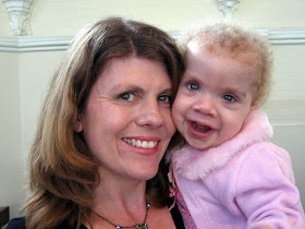 picture of steph with Daisy when she was about 3, wearing a pink cardigan