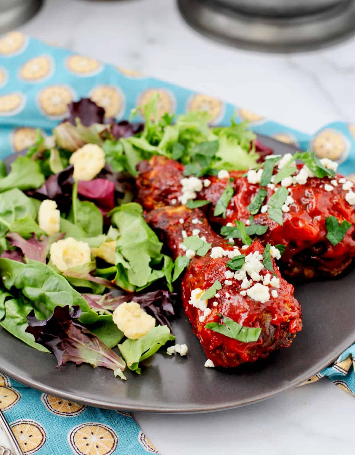 Dirty Fried Chicken legs with salad.