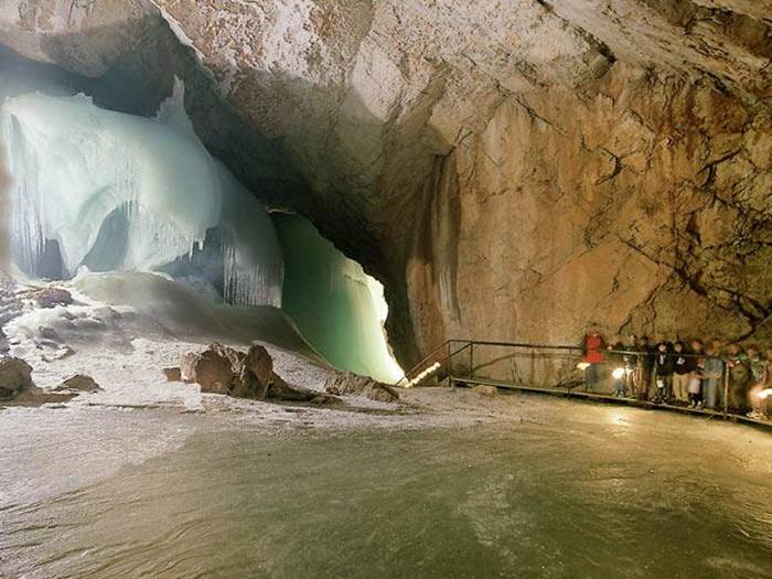 The Eisriesenwelt (German for "World of the Ice Giants") is a natural limestone ice cave located in Werfen, Austria, about 40 km south of Salzburg. The cave is inside the Hochkogel mountain in the Tennengebirge section of the Alps. It is the largest ice cave in the world, extending more than 42km and visited by about 200,000 tourists every year.