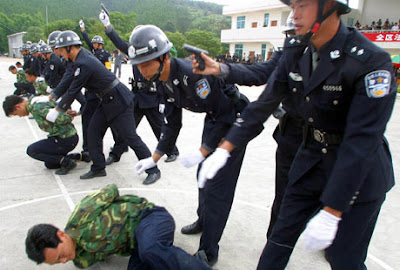 Chinese police officers demonstrating execution procedure