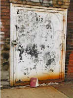 white door in a Braddock alley