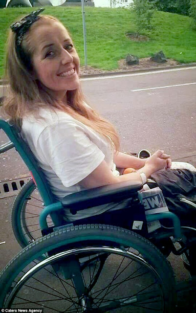 A smiling woman in a wheelchair