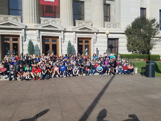 Large group of middle school students posing for picture for field trip to the Statehouse