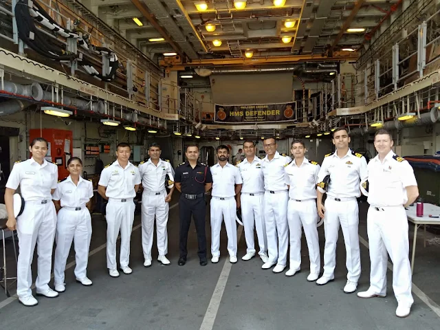 Image Attribute: HMS Defender crew with India Navy officials at Mormugao Port, Goa / Dated: November 10, 2019. / Source: Indian NavyImage Attribute: HMS Defender crew with India Navy officials at Mormugao Port, Goa / Dated: November 10, 2019. / Source: Indian Navy