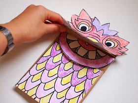 Glue on all the dragon pieces to your paper bag