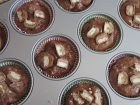 Food Lust People Love: Twix Muffins combine a sweet chocolate batter with crunchy Twix bars inside and on top for a batch of great snack muffins the whole family will love.