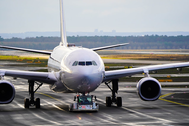 aircraft being towed on runway:Photo by Jan Rosolino on Unsplash