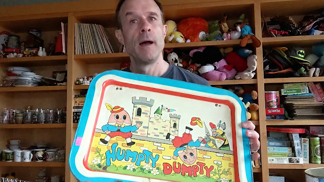 Picture of man holding tray with illustrations