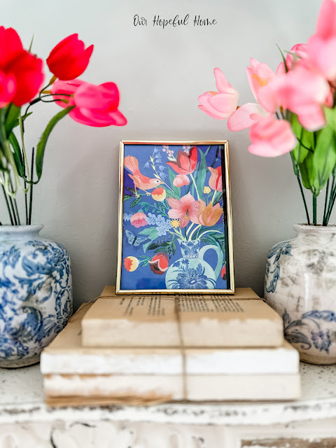 flowers and birds in gold frame on books