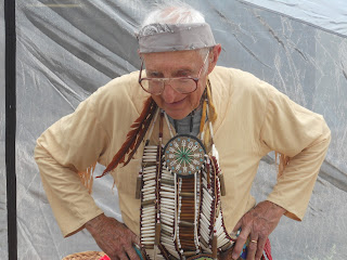 golden volunteer in beads and feathers