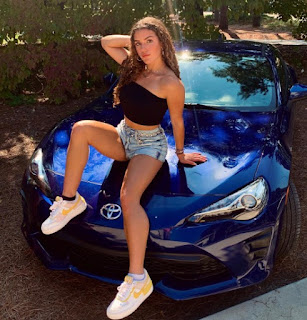 McKinzie Valdez posing for the picture with the car