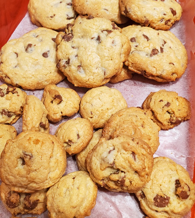 a pile of soft chocolate chip cookies on the counter