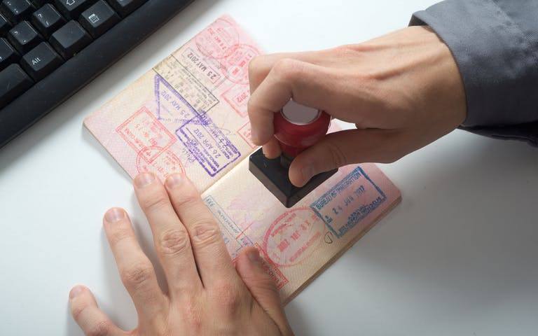 Passport with visa stamping page