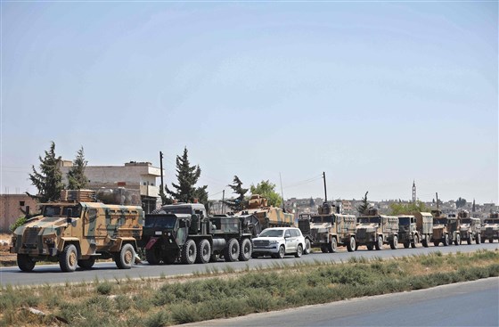 A convoy of Turkish military vehicles travels on a highway near the town of Saraqib in Syria's northern Idlib province on Wedneday.