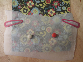 two hairclips and two magnets secure the greaseproof paper to the patterned paper