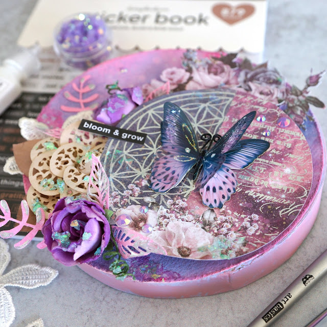 Prima Moon Child, Pretty Pale and Soprano flowers and lace trim; Tim Holtz Distress Spray Oxide and Stain in kitsch flamingo and dusty concord and Funky Floral dies; Scrapbook.com stickers and smart glue adhesives; Pinkfresh Essentials jewels