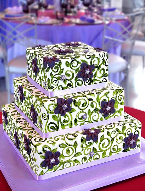 Stunning three tier purple and green wedding cake decorated with lilac 
