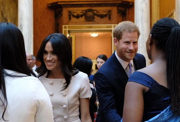 Meghan Markle wore Aquazzura Deneuve Bow Pointy Toe Pump. The Duchess carried a Biblioteque Saffiano Leather Chain Clutch by Prada