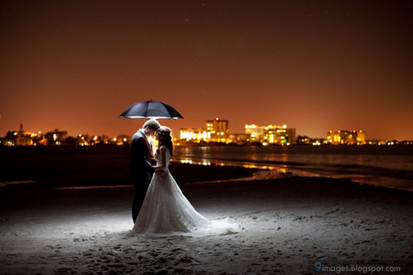 Hugging married couple under umbrella romantic |
