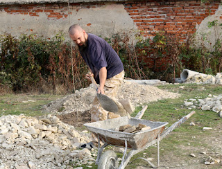 Shoveling stones into the wheelbarrow