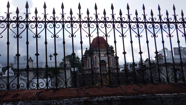 grilled fence of eerie-looking cemetery campo santo de san joaquin iloilo