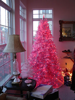 A pink Christmas lit up in a cozy household scene