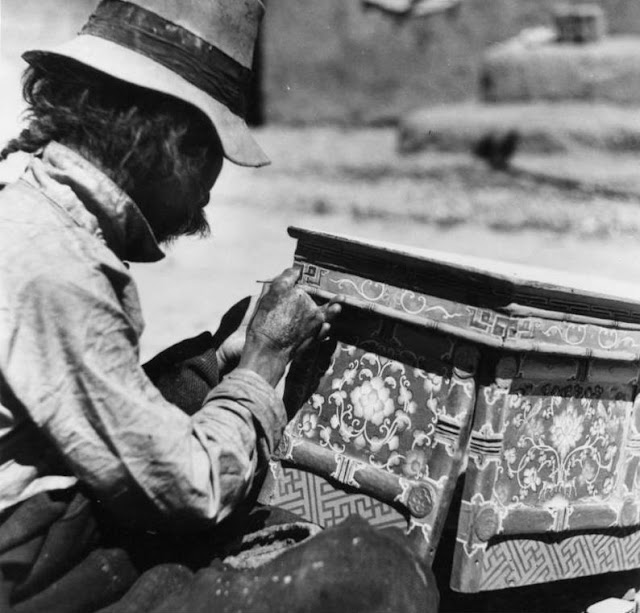 Tibetan craftsman painting a table.