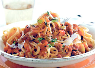 Basic bolognese sauce with beef served on a bed of spaghetti and garnished with parmesan shavings