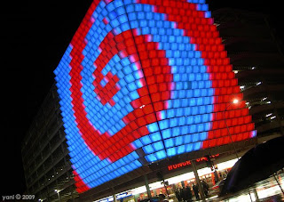 is it a red spiral on a blue background or a blue spiral on a red background?