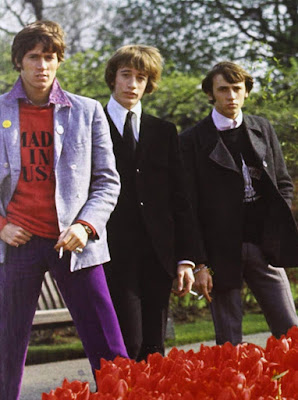 Bee Gees standing in a garden