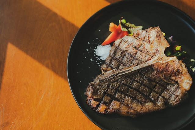 A grilled steak sitting on a plate.