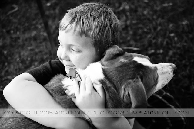 black and white photo of a boy and his dog