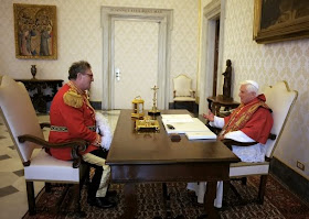 Pope Benedict XVI speaks with the new Grand Master of the Knights of Malta, Matthew Festing of Britain, during their meeting at the Vatican