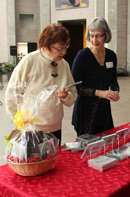 Michèle helps a fan choose a cd.