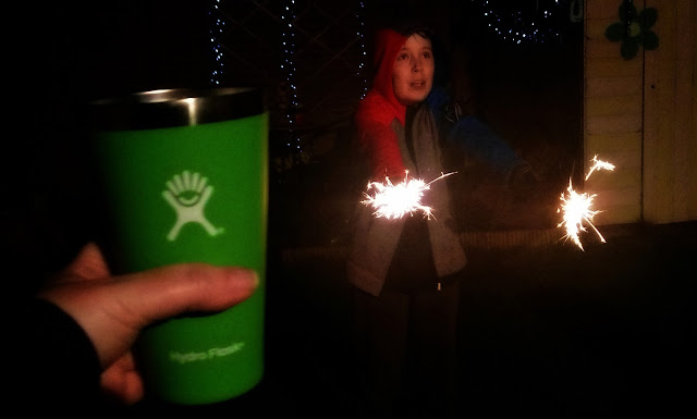 Boy with sparklers, featuring Hydro Flask True Pint cup in foreground. 